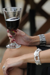 Woman's hand holding a wine glass