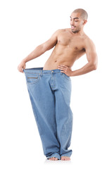 Fototapeta premium Man in dieting concept with oversized jeans