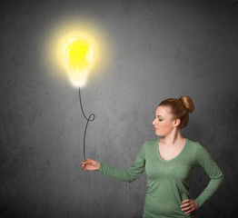 Woman holding a lightbulb balloon