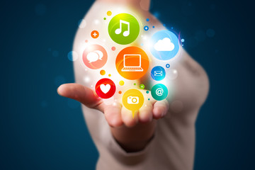 Young woman presenting colorful technology icons and symbols