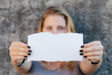 teenage girl in casual clothes holding blank sheet of paper - 56120480