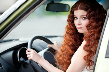 Plakat Woman sitting in car