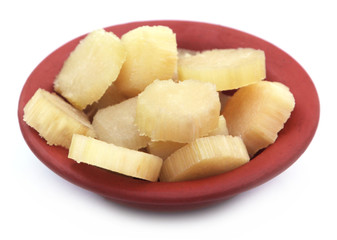 Pieces of Sugarcane on a brown bowl