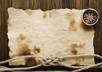 Rope and compass on the old paper background