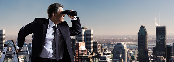 Businessman with binoculars.