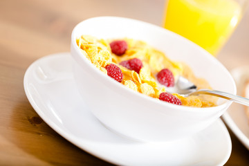 Close up of plate with muesli and strawberry at the kitchen