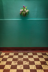 Retro interior with green wall background and checkered floor.