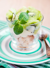 Kiwi Eton mess - dessert with meringue, whipped cream and fruits