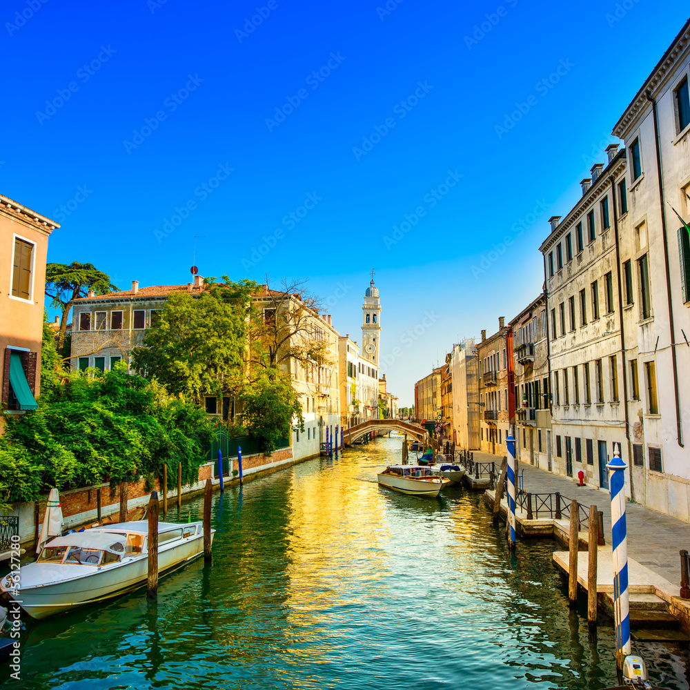 Wall mural venice sunset in water canal and church on background. italy