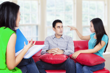 Young couple consults talking to psychologist