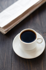Newspaper and cup of coffee on table