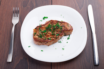 Grilled steak on white plate