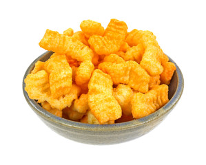 Crunchy cheddar cheese snacks in an old bowl