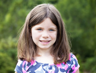 Pretty young girl portrait smiling outdoors