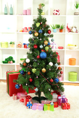 Decorated Christmas tree on home interior background