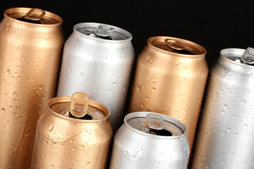 Aluminum cans with water drops isolated on black