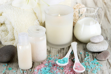 Beautiful spa setting with lily on wooden table close-up