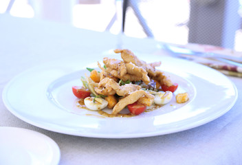 Caesar salad on white plate, close up