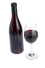 Glass full of red wine and bottle.