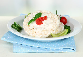Tasty crispbreads with vegetables on white table