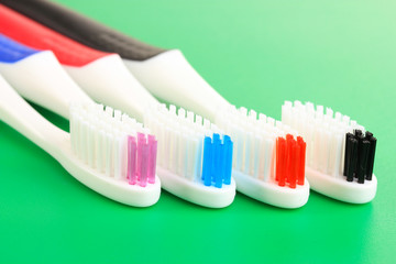 Tooth-brushes on green background