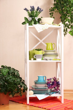 Beautiful white shelves with tableware and decor,