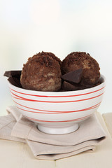 Tasty ice cream scoops in bowl, on wooden table