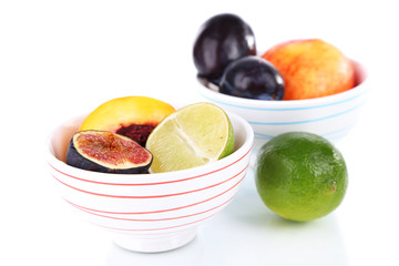 Fruit in small bowls isolated on white