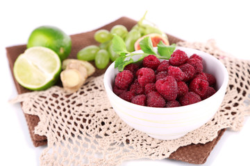 Raspberries in small bowl on napkin isolated on white