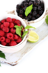 Raspberries and blackberry in small bowls