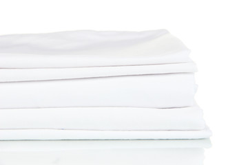 Stack of clean bedding sheets isolated on white