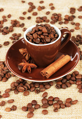 Coffee beans in cup on table close-up