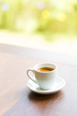 close up a cup of coffee on wooden table