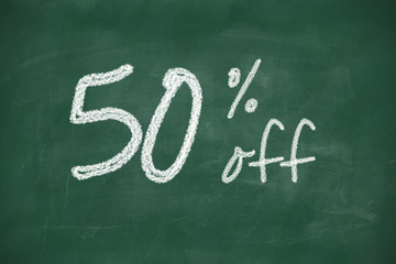 50 percent discount sign written with chalk