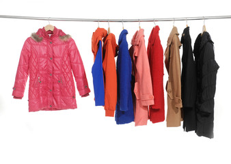 Set of colorful jacket, coat hanging on hanger - obrazy, fototapety, plakaty