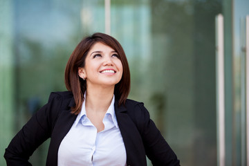 Fototapeta premium Happy businesswoman looking up