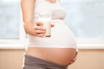 pregnant girl and milk glass