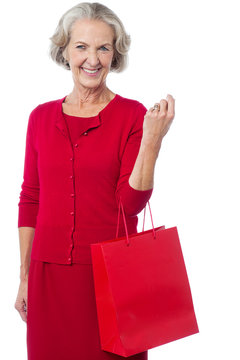 Senior Woman Holding Red Shopping Bag