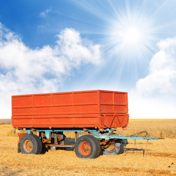 A Empty Tractor Trailer On A Wheat Field.