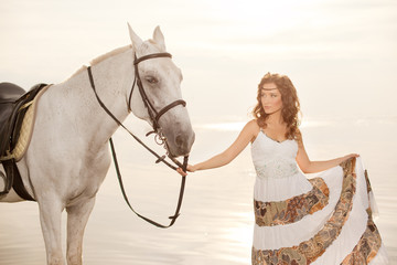 Young woman on a horse. Horseback rider, woman riding horse on b