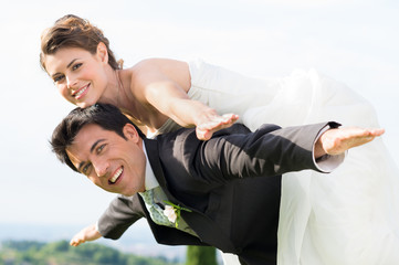 Bride and groom piggyback