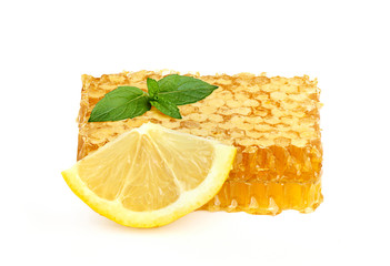 Honey in honeycombs with lemon and mint.