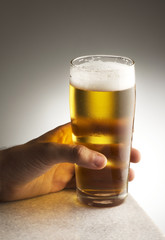 Hand with a glass of beer