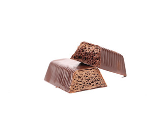 Broken bar of chocolate on a white background.