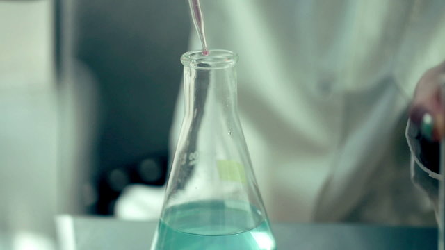 Scientist doing experiment with chemicals in lab