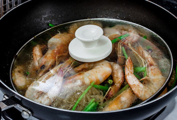 stir noodle with prawns cooking in a pan