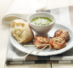 meditarian meat skewers served with bread and pesto