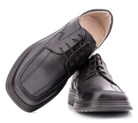 Black glossy man’s shoes with shoelaces