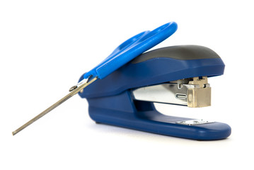 Scissors on stapler over isolated white background