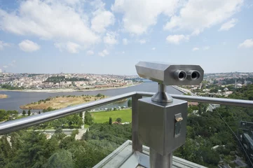 Fotobehang Binoculars on an aerial viewing platform over city © Paul Vinten